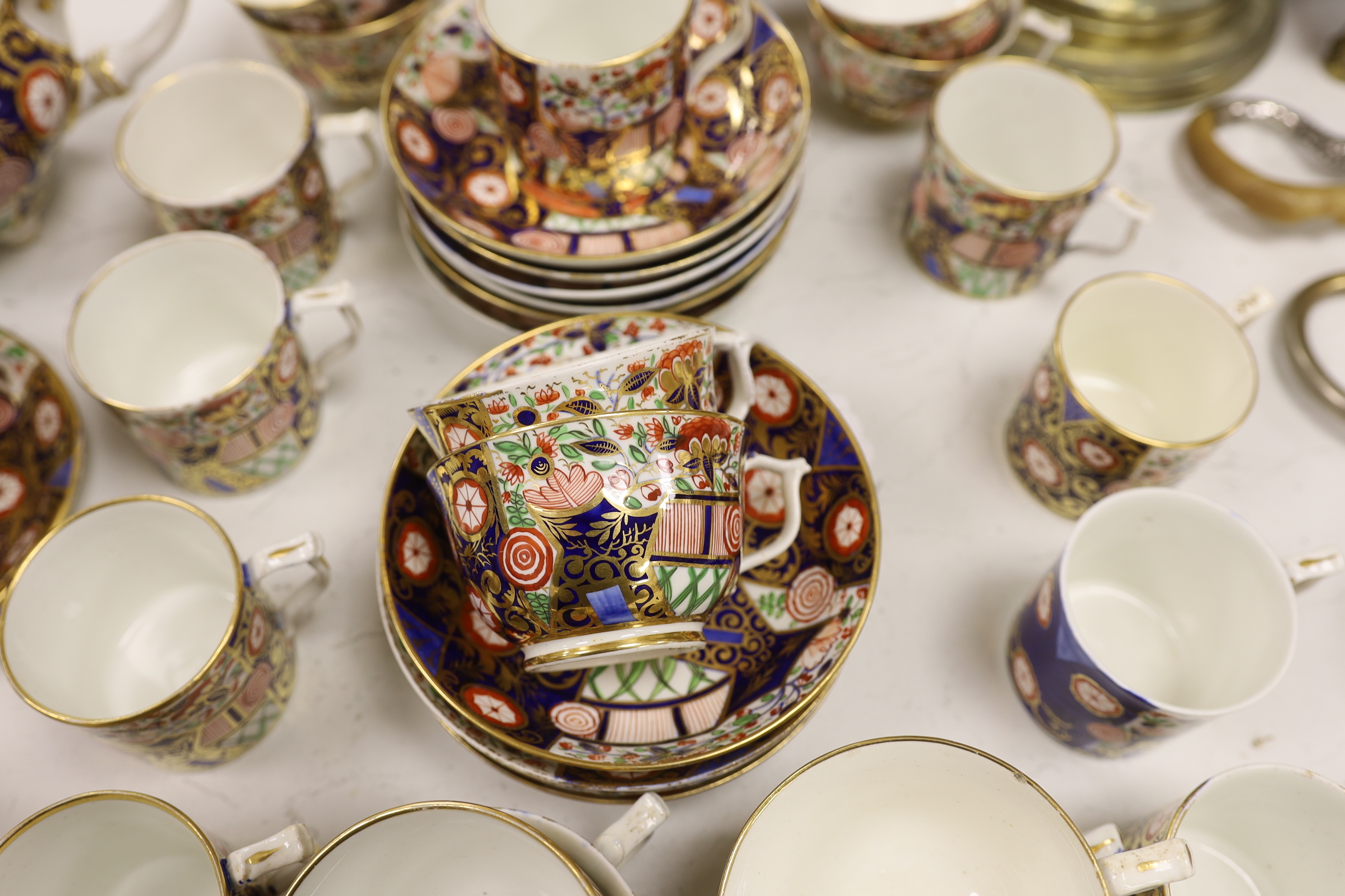 An early 19th century Derby Japan pattern part tea and coffee set, including cups and saucers, teapot, milk jug and bowl